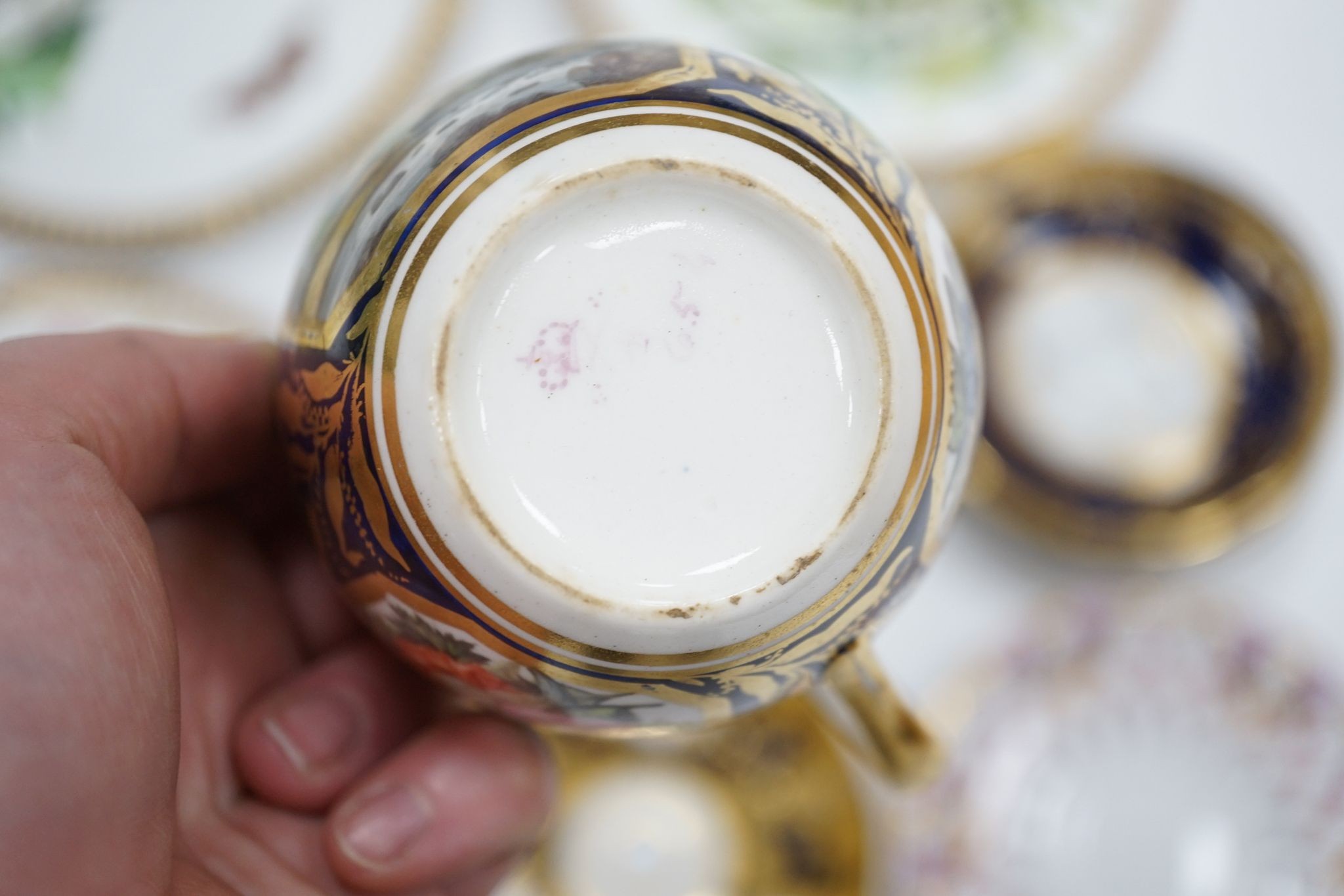 A small collection of Victorian porcelain tea cups and saucers and sundry dessert plates